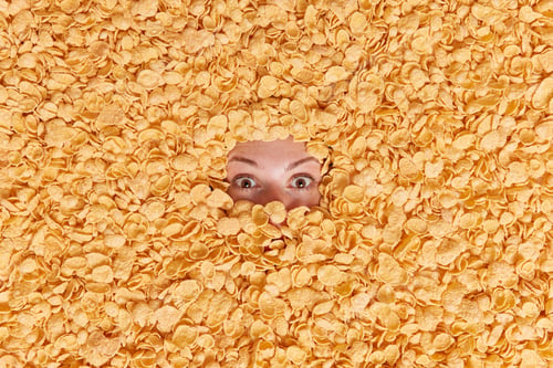 Preview: Shocked Young Woman Buried In Cereals Has Healthy Nutrition Surriunded By Cornflakes Hides In Food