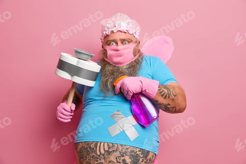 Preview: Scared Bearded Man Helper Ready To Clean Your House Stares Fearful At Camera Poses With Detergent