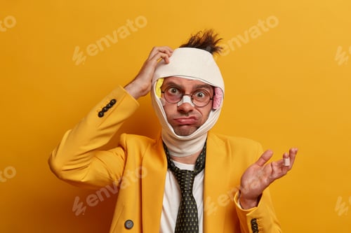 Preview: Puzzled Nerd Man Scratches Head And Gestures With Hesitation, Recovers After Serious Injury Or