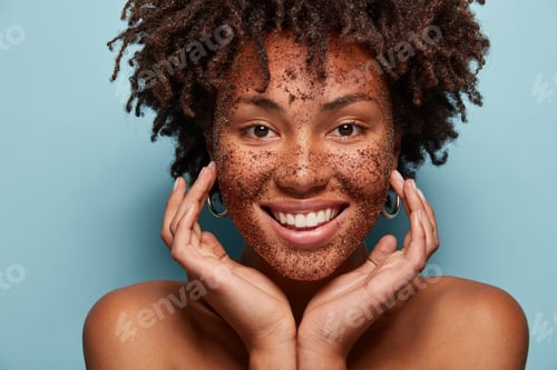 Preview: Photo Of Smiling Black Woman Has Cleansing Mask Or Scrub On Face, Smiles Broadly, Enjoys Beauty