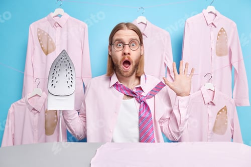 Preview: Young Shocked Man Being In Panic Stares Surprisingly At Camera Hurries And Dresses For Work Iron