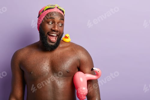 Preview: Funny Dark Skinned Father Buys Swimming Accessories For Child, Looks Happily At Small Rubber