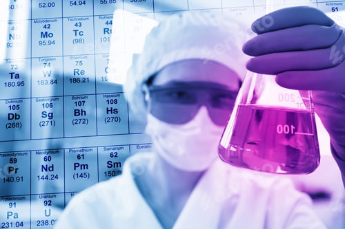 Preview: Scientist Working In The Lab, In Protective Mask And Cap, Examines A Test Tube With Liquid