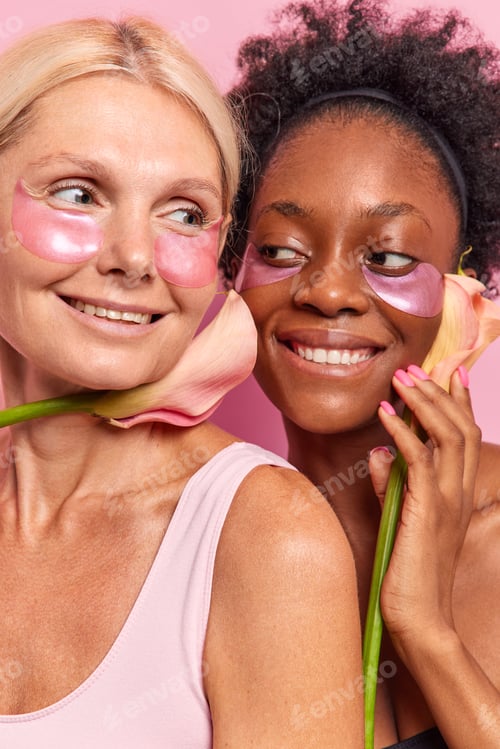 Preview: Vertical Shot Of Two Happy Women Take Care Of Complexion Apply Beauty Moisturising Patches Under