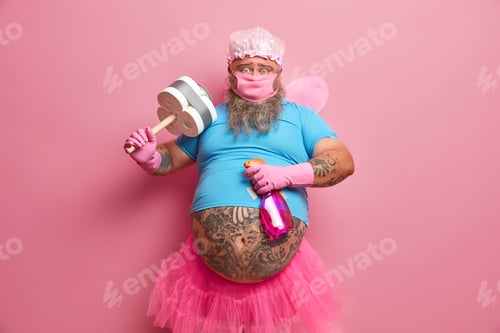 Preview: Hard Working Bearded Man Busy With Housekeeping, Dressed In Fairy Costume To Entertain Customers