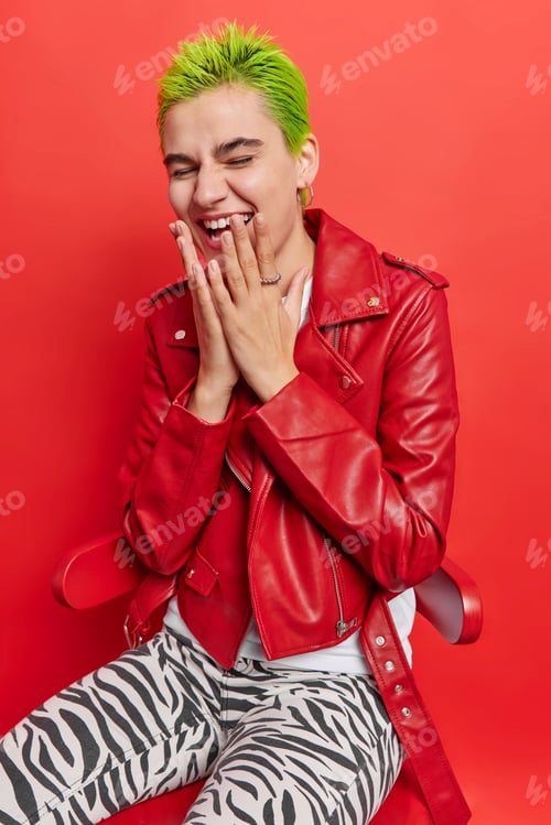 Preview: Photo Of Overjoyed Hipster Girl With Green Trendy Hair Laughs At Something Dressed In Leather