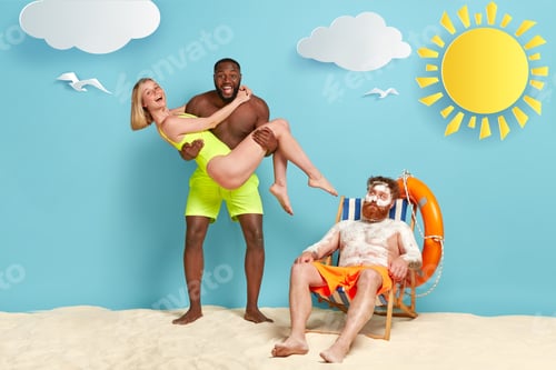 Preview: Photo Of Happy Dark Skinned Guy Carries Girlfriend In Swimsuit On Hands, Foolish Together At Beach