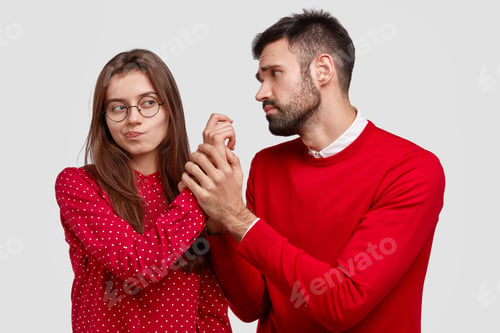 Preview: Desperate Young Caucasian Man Holds Hand Of Girlfriend, Looks With Miserable Expression, Asks For