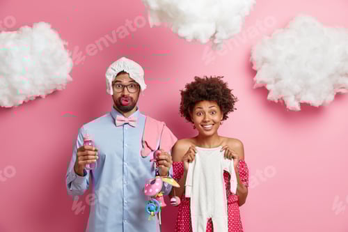 Preview: Happy Family And Pregnancy Concept. Positive Expectant Woman Poses With Baby Romper, Bearded Future