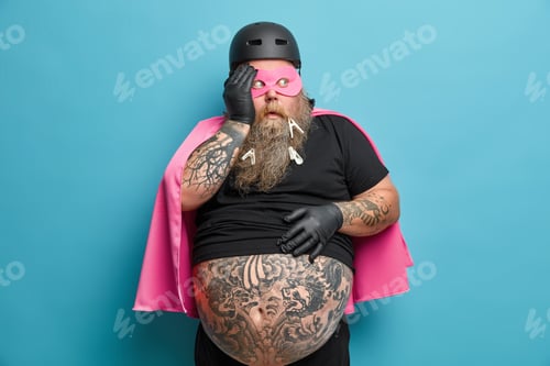 Preview: Scared Emotional Bearded Adult Man Looks Away With Fearful Expression Holds Breath And Wears