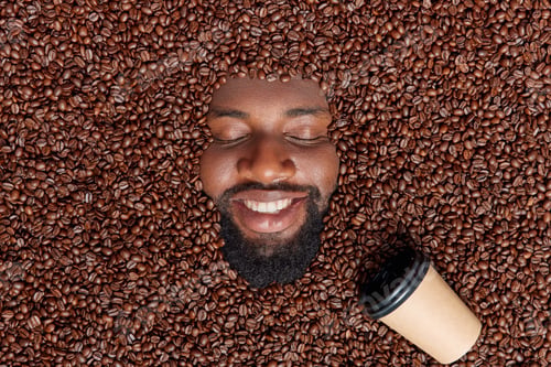 Preview: Glad Bearded Afro American Man Drowned In Aromatic Coffee Beans Prepares Delicious Refreshing