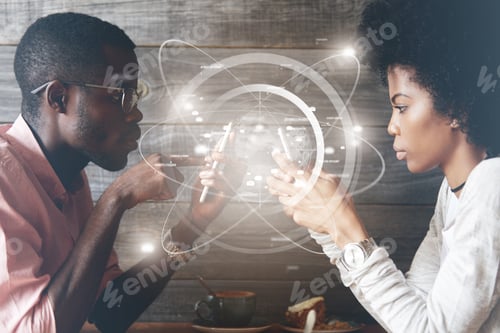 Preview: Two Successful Partners Working Together Using Modern Mobile Phones With Futuristic Interface While