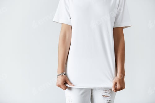 Vista previa: Cropped Portrait Of Fashionable Young Female In Ragged Denim Pants And White T-Shirt With Copy
