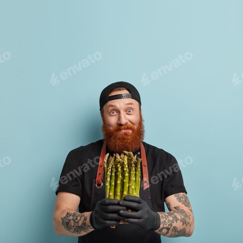 Preview: Eating Vegetables Concept. Delighted Joyful Bearded Man Holds Bunch Of Delicacy Fresh Green