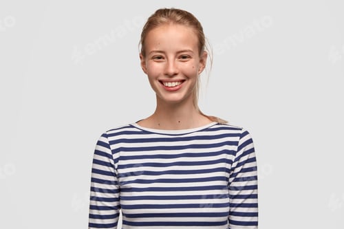 Preview: Cute Female Teenager Has Broad Smile, Wears Striped Sweater, Being In Good Mood After Unforgettable