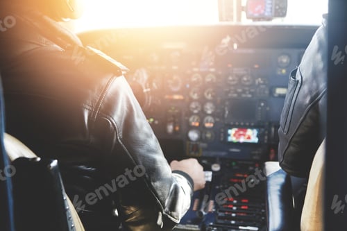 Preview: Two Unrecognizable Jet Airliner Pilots Wearing Leather Jackets Piloting Aircraft At Sunset, Sitting