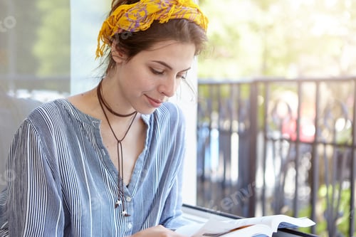 Preview: Educational And Leisure Concept. Fashionable Caucasian Woman With Headband And Casual Shirt Sitting