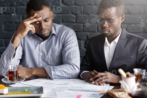 Preview: Candid Shot Of Two Handsome African-American Business Partners Having Frustrated Looks, Focused On