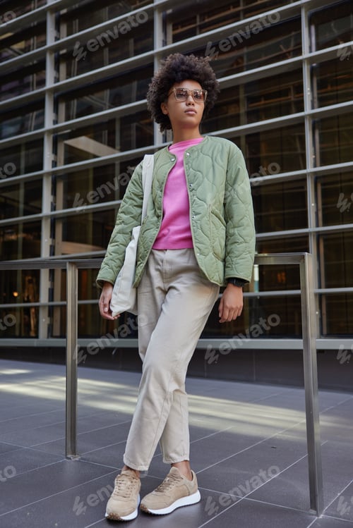 Preview: Full Length Shot Of Stylish Woman With Curly Hair Wears Fashionable Clothes Trendy Sunglasses