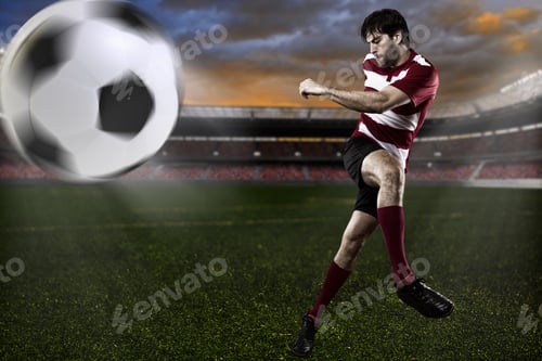 Preview: Soccer Player In A Red Uniform Kicking A Ball.