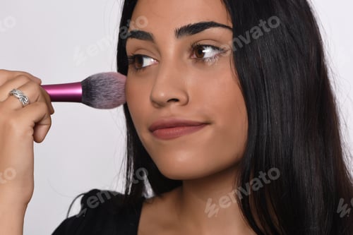 Preview: Young Beautiful Woman Applying Make Up. Isolated White Background.