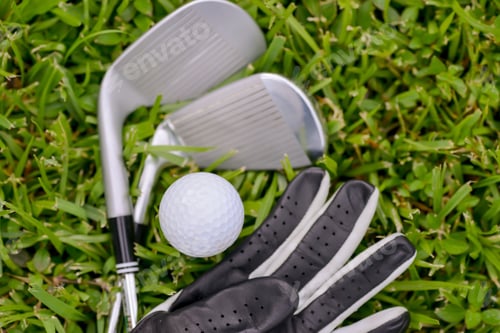 Preview: Golf Irons And Ball With Leather Glove On The Fairway Grass