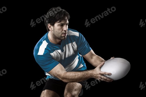 Preview: Rugby Player In A Blue Uniform. Black Background.
