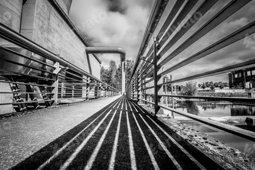 Preview: A Grayscale Shot Of A Bridge Under A Cloudy Sky