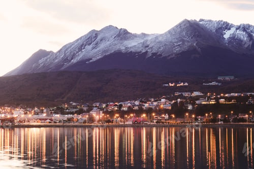 Preview: A Village On The River At The Sunset With Mountains At Back.