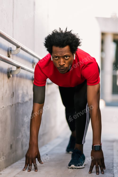 Preview: Athlete Man In Start Position Preparing To Run Outdoors.
