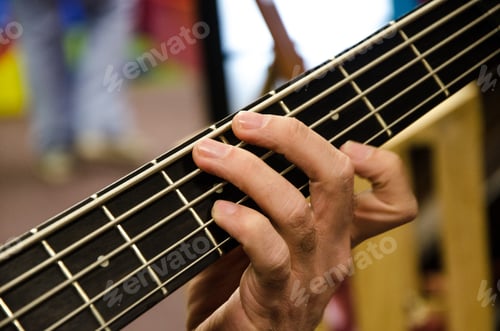 Preview: Closeup Of Photo Of Electric Bass Guitar Player Playing With Hands