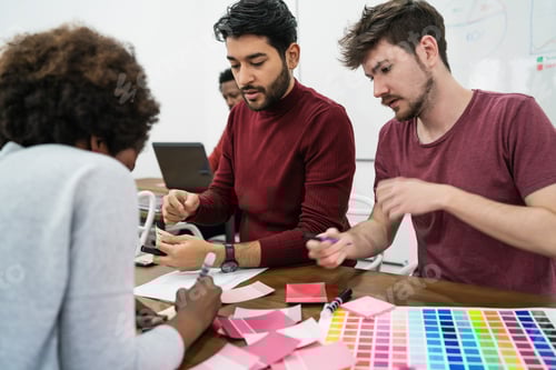 Preview: Young Creative Designers Working In A Project And Discussing New Order Development On Workplace