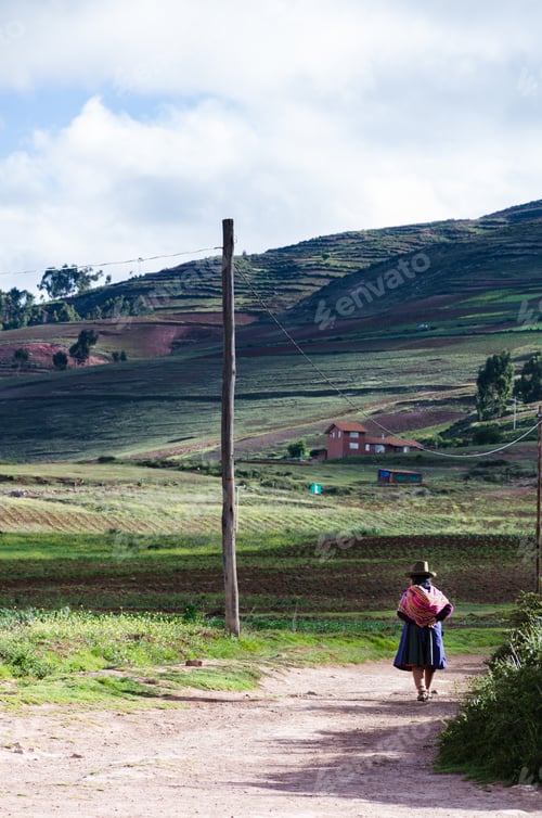 Preview: Native Old Woman With Colorful Traditional Clothes From The City Of Cusco, Walking On A Path.
