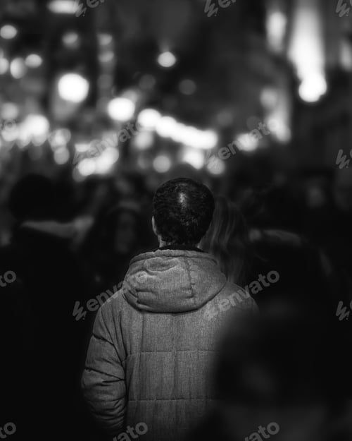 Preview: A Vertical Grayscale Shot Of A Male Standing In The Crowd
