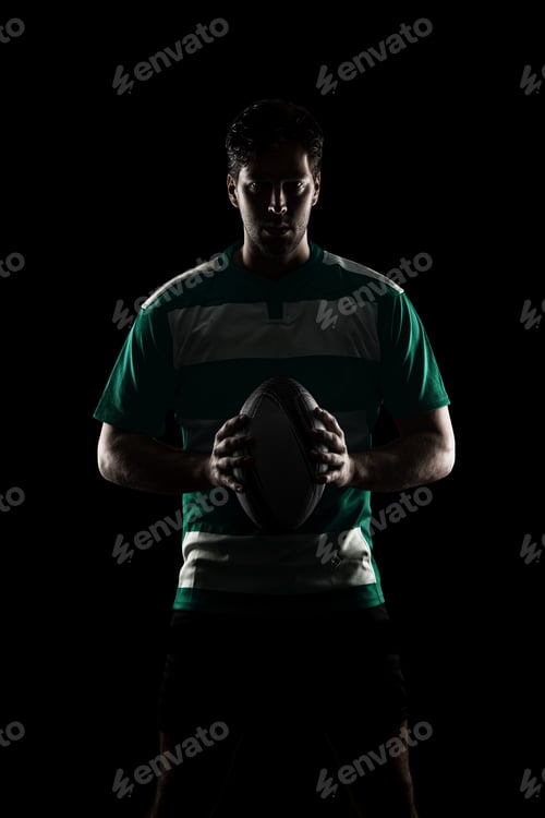 Preview: Rugby Player In A Green Uniform. Black Background