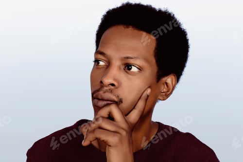 Preview: Portrait Of Afro American Thinking Man With Hand Near Face On Studio.