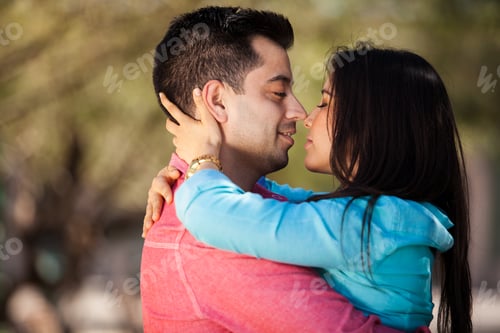 Preview: Portrait Of A Young Romantic Hispanic Couple About To Kiss Each Other
