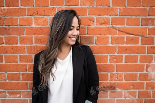 Preview: Portrait Of Young Latin Woman Posing Outdoors Against Brick Wall. Urban Concept.
