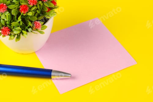 Preview: Woman Hands Holding Empty Note Paper With Pen On Yellow Background