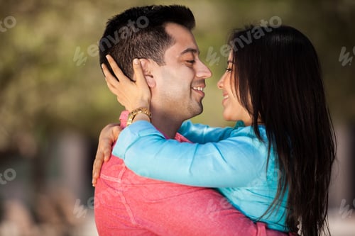 Preview: Young Hispanic Couple Embracing Each Other And About To Kiss