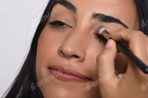 Preview: Young Beautiful Woman Applying Eyeshadow. Isolated White Background.