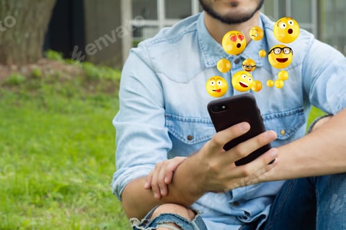 Preview: Close-Up Of Man Using Smartphone Sending Emojis. Social Concept.