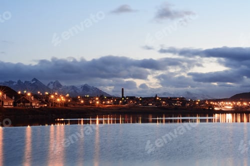 Preview: A Village On The River At The Sunset With Mountains At Back.