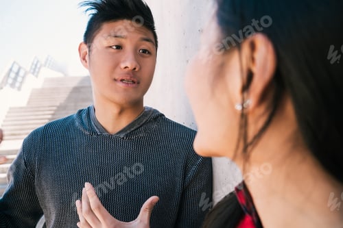 Preview: Portrait Of Lovely Asian Couple Having A Conversation While Looking At Each Other.