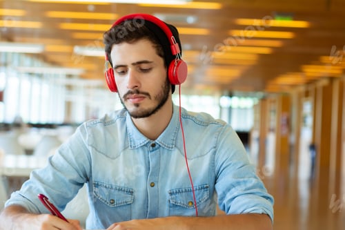 Preview: Portrait Of Young Male Student Working In The University Library.