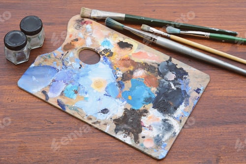 Preview: Artist'S Palette With Colorful Oil Paint Strokes And Paintbrushes On Wooden Background. Art Concept