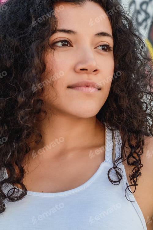 Preview: Portrait Of Young Latin Woman Against Graffiti Wall. Outdoors. Urban Concept.