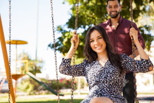 Preview: Pretty Young Brunette Playing In A Swing While Her Boyfriend Pushes Her