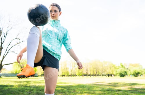 Preview: Portrait Of Young Woman Practicing Soccer Skills And Doing Tricks With The Football Ball. Soccer