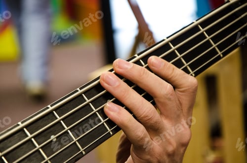 Preview: Closeup Of Photo Of Electric Bass Guitar Player Playing With Hands